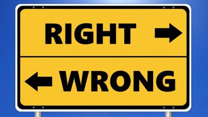 A road sign with two arrows: "RIGHT" pointing right and "WRONG" pointing left, both in bold black text on a yellow background.