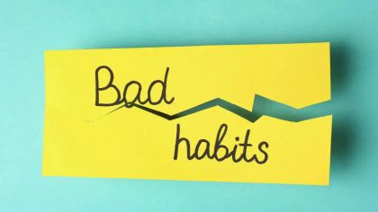 A torn yellow paper with the words "Bad habits" written in black, set against a light blue background.