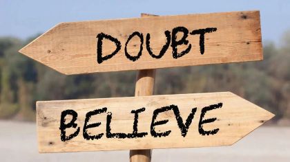 Two wooden signposts pointing in opposite directions, labeled "Doubt" and "Believe."